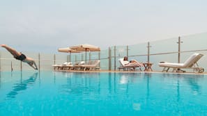 Outdoor pool, open 6:00 AM to 10:00 PM, pool umbrellas, pool loungers
