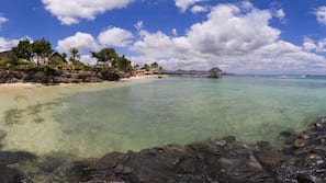 On the beach, white sand, sun-loungers, beach umbrellas