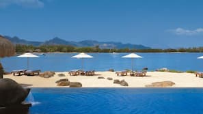 On the beach, white sand, sun-loungers, beach umbrellas