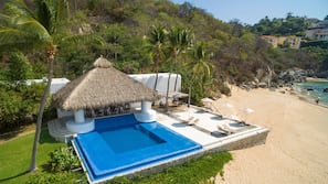 On the beach, white sand, sun loungers, beach umbrellas