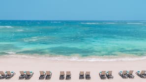 On the beach, sun loungers, beach umbrellas, beach towels