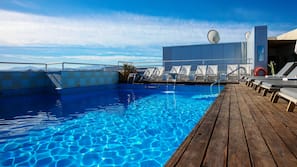 Seasonal outdoor pool, open 10:30 AM to 8:00 PM, pool umbrellas