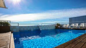 Seasonal outdoor pool, open 10:30 AM to 8:00 PM, pool umbrellas