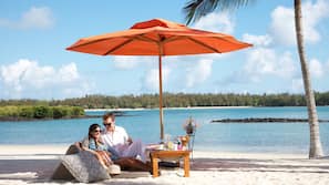On the beach, white sand, sun loungers, beach umbrellas
