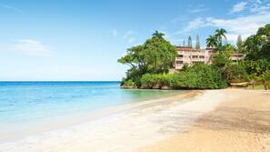 White sand, beach towels, water skiing, windsurfing