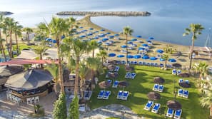 On the beach, sun-loungers, beach umbrellas, beach towels