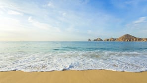 On the beach, white sand, sun loungers, beach umbrellas