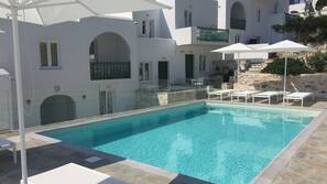 Seasonal outdoor pool, open 8 AM to 7:00 PM, pool umbrellas