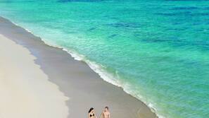 On the beach, sun-loungers, beach umbrellas, beach towels
