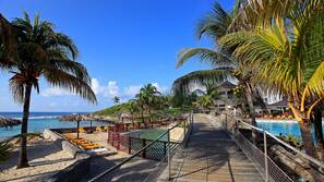 On the beach, white sand, sun loungers, beach bar