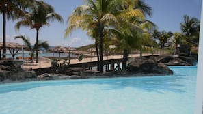 On the beach, white sand, sun loungers, beach bar