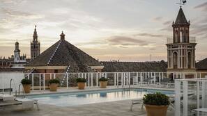 Seasonal outdoor pool, open noon to 9 PM, pool umbrellas, pool loungers