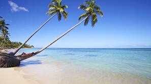 Een privéstrand, parasols, strandlakens, duiken