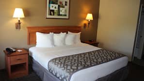 Premium bedding, desk, laptop workspace, blackout drapes