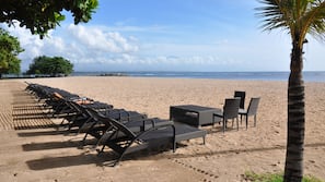 On the beach, white sand, sun-loungers, beach towels