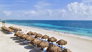 On the beach, white sand, beach umbrellas, beach towels