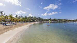 On the beach, white sand, sun-loungers, beach umbrellas