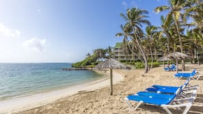 On the beach, white sand, sun-loungers, beach umbrellas