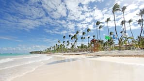 Private beach, white sand, sun loungers, beach umbrellas