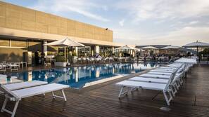 Seasonal outdoor pool, open 10:00 AM to 7:00 PM, pool umbrellas