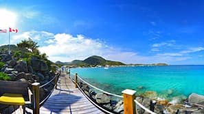 On the beach, white sand, sun loungers, beach towels