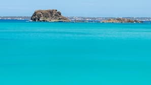 On the beach, white sand, sun loungers, beach towels