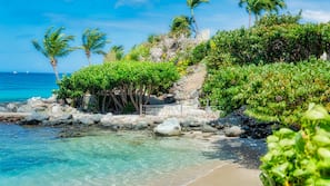 On the beach, white sand, sun loungers, beach towels