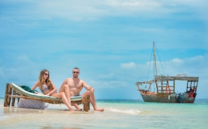 On the beach, white sand, sun loungers, beach umbrellas