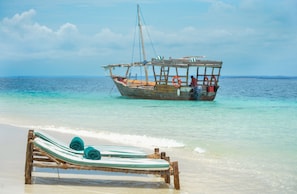 On the beach, white sand, sun loungers, beach umbrellas