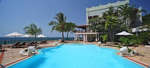 Outdoor pool, pool umbrellas, lifeguards on site