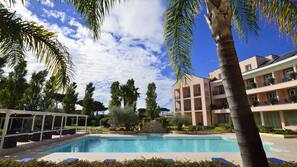 Seasonal outdoor pool, pool umbrellas, pool loungers
