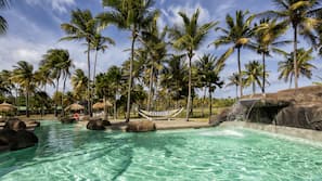 Outdoor pool, a waterfall pool, pool umbrellas, sun loungers