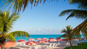 On the beach, white sand, sun loungers, beach umbrellas