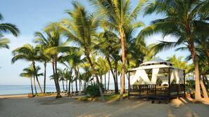 On the beach, sun loungers, beach towels, windsurfing