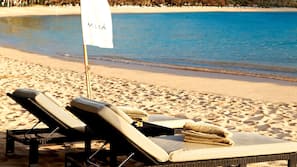 Beach nearby, white sand, beach towels, beach volleyball