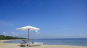 Beach nearby, white sand, beach towels, beach volleyball