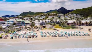 On the beach, white sand, sun loungers, beach umbrellas