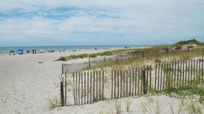 On the beach, white sand, beach umbrellas, beach towels