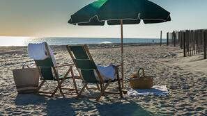 On the beach, white sand, beach umbrellas, beach towels