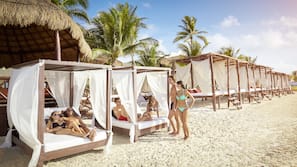 On the beach, white sand, beach umbrellas, beach towels