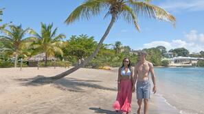 On the beach, sun-loungers, beach umbrellas, sailing