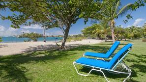 On the beach, sun-loungers, beach umbrellas, sailing