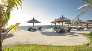 On the beach, white sand, sun-loungers, beach massages