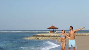 On the beach, white sand, sun-loungers, beach massages