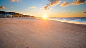 On the beach, white sand, sun loungers, beach umbrellas