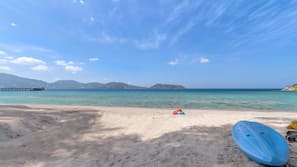 On the beach, white sand, beach umbrellas, beach towels