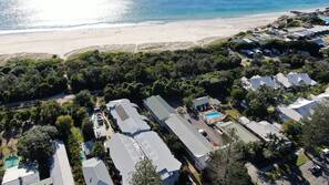 Beach nearby, white sand, beach towels