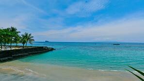 On the beach, white sand, beach umbrellas, beach towels
