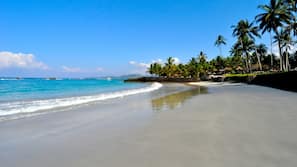On the beach, white sand, beach umbrellas, beach towels