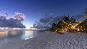 White sand, beach towels, windsurfing, surfing